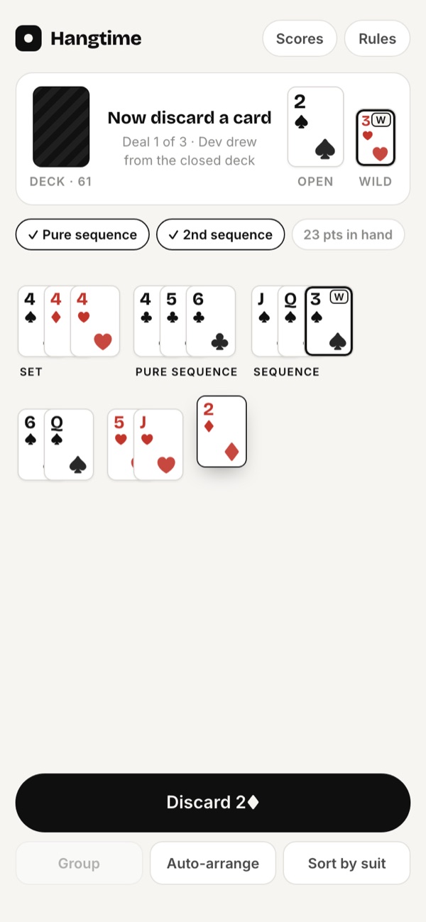 A phone showing a Rummy hand arranged into a set and sequences, with hints